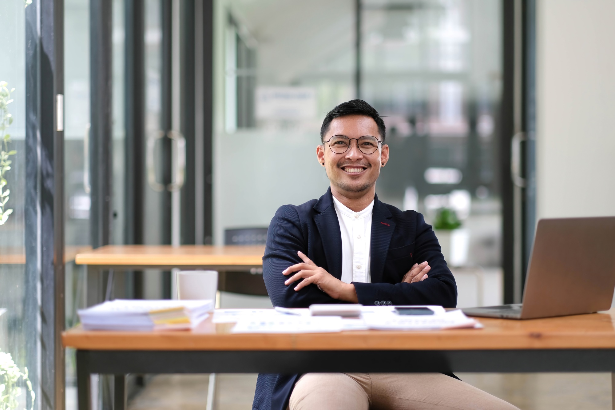 Portrait of successful handsome executive businessman smart looking at camera and smiling, happy in